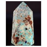 Amazonite Tower is a beautifully polished crystal tower that showcases the soothing, turquoise-green hues of amazonite, often accented with natural striations and subtle white veining.