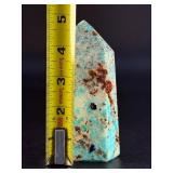 Amazonite Tower is a beautifully polished crystal tower that showcases the soothing, turquoise-green hues of amazonite, often accented with natural striations and subtle white veining.