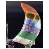 Moon-Shaped Crystal with Red Jasper, Tiger Eye, Sodalite, Charoite, Aventurine, Howlite & Amethyst is a vibrant, multi-stone piece carved into a graceful crescent moon.