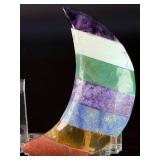 Moon-Shaped Crystal with Red Jasper, Tiger Eye, Sodalite, Charoite, Aventurine, Howlite & Amethyst is a vibrant, multi-stone piece carved into a graceful crescent moon.