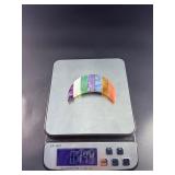 Moon-Shaped Crystal with Red Jasper, Tiger Eye, Sodalite, Charoite, Aventurine, Howlite & Amethyst is a vibrant, multi-stone piece carved into a graceful crescent moon.