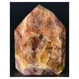 Super 7 Tower is a powerful and highly sought-after crystal carved into a polished towerthat showcases the natural blend of seven minerals: amethyst, clear quartz, smokyquartz, rutile, goethite, lepid
