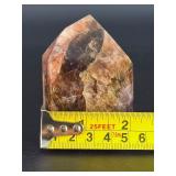 Super 7 Tower is a powerful and highly sought-after crystal carved into a polished towerthat showcases the natural blend of seven minerals: amethyst, clear quartz, smokyquartz, rutile, goethite, lepid