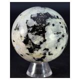 Rainbow Moonstone Sphere is a luminous and enchanting crystal sphere known for its soft glow and mesmerizing flashes of blue, rainbow, and pearly light that shimmer as it moves.