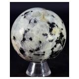 Rainbow Moonstone Sphere is a luminous and enchanting crystal sphere known for its soft glow and mesmerizing flashes of blue, rainbow, and pearly light that shimmer as it moves.