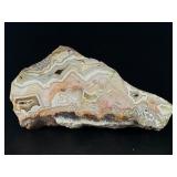 Laguna Lace Agate (Partial Polished) is a striking natural piece that beautifully balances raw texture with smooth, polished detail.