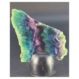 Rainbow Fluorite Slab is a stunning, polished slice that showcases fluorite’s signature bands of purple, green, blue, and soft teal hues.