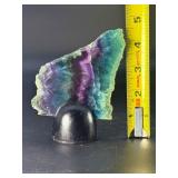 Rainbow Fluorite Slab is a stunning, polished slice that showcases fluorite’s signature bands of purple, green, blue, and soft teal hues.