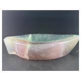 Fluorite Leaf Dish is a hand-carved crystal piece shaped like a delicate leaf bowl, showcasing the natural banding and vibrant colors of fluorite.