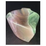 Fluorite Leaf Dish is a hand-carved crystal piece shaped like a delicate leaf bowl, showcasing the natural banding and vibrant colors of fluorite.