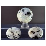 Rainbow Moonstone Sphere and Palm Stones are enchanting pieces that showcase the soft, luminous glow and signature flashes of rainbow sheen unique to rainbow moonstone.