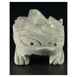 Hand-Carved Quartz Frog Cluster is a charming and energetically vibrant crystal piece, expertly carved into the shape of a frog while preserving the natural beauty of the quartz cluster.