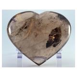 Large Smoky Quartz Heart with Rainbows & Inclusions is a striking, hand-polished crystal heart. The rich, earthy tones of smoky quartz along with natural internal inclusions that create captivatin