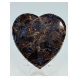 Arfvedsonite Heart Dish is a beautifully hand-carved crystal dish shaped like a heart, showcasing the deep, inky blue-black tones and striking natural patterns of arfvedsonite.