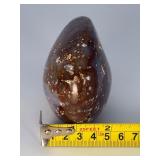 Orbs Ocean Jasper Palm Stone is a smooth, hand-polished crystal shaped to fit comfortably in the palm, showcasing the signature orb-like patterns and soothing earthy tones of ocean jasper.