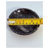 Orthoceras Fossil Bowl is a striking, hand-carved display piece featuring the elongated, jet-black orthoceras fossils embedded in a smooth, polished matrix.
