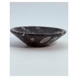 Orthoceras Fossil Bowl is a striking, hand-carved display piece featuring the elongated, jet-black orthoceras fossils embedded in a smooth, polished matrix.