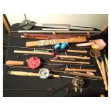 Bucket of vintage ice fishing sticks, reels and more