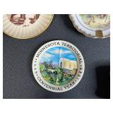 Collection of Vintage Souvenir Plates, Wicker Basket, Russian Nesting Doll, and Decorative Items