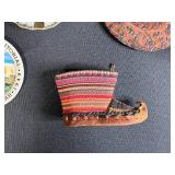 Collection of Vintage Souvenir Plates, Wicker Basket, Russian Nesting Doll, and Decorative Items