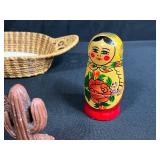 Collection of Vintage Souvenir Plates, Wicker Basket, Russian Nesting Doll, and Decorative Items