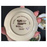 Collection of Vintage Souvenir Plates, Wicker Basket, Russian Nesting Doll, and Decorative Items