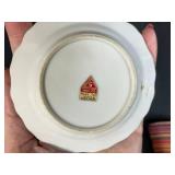 Collection of Vintage Souvenir Plates, Wicker Basket, Russian Nesting Doll, and Decorative Items