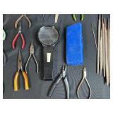 Collection of Hand Tools with Pliers, Files, Screwdrivers, and Magnifier