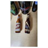 Collection of Beer Memorabilia including Schlitz Pitcher, Budweiser Mardi Gras 2001 Bottle, and Bad Habit Brewing Growler
