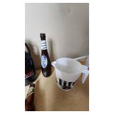 Collection of Beer Memorabilia including Schlitz Pitcher, Budweiser Mardi Gras 2001 Bottle, and Bad Habit Brewing Growler