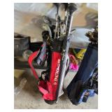 Spalding and Dunlop Golf Club Bags with Various Clubs