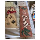 Christmas-themed decorations including Santa signs and candle holder, plus holiday decor items