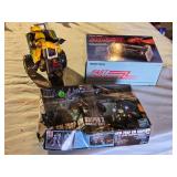 Radio Shack Fast Charger and a RGM-79SP GM Sniper II model kit, and a toy ATV with rider.