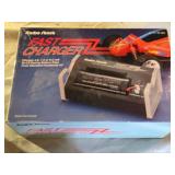 Radio Shack Fast Charger and a RGM-79SP GM Sniper II model kit, and a toy ATV with rider.