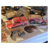Assorted Toy Vehicles and Accessories Lot including Monster Trucks, Cars, and Tank