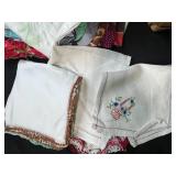 Vintage Handkerchief and Linen Collection with Basket, Flour Sack Apron, and Wooden Wine Holder