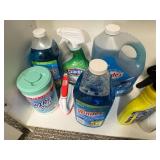 Tall White Storage Cabinet with Assorted Household Supplies