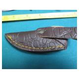 Hand crafted knife with a leather s...
