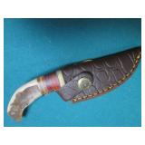 Hand crafted knife with a leather s...