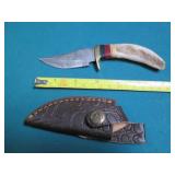 Hand crafted knife with a leather s...