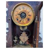 Antique Wooden Mantel Clock with Ornate Carving and Glass Door