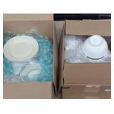 Two Boxes Filled With White Dishes