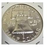 1963 Franklin Half Dollar, graded MS-69, plus four pennies from 1961 and 1963 with varying grades and defects.