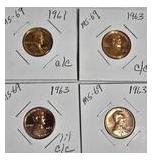 1963 Franklin Half Dollar, graded MS-69, plus four pennies from 1961 and 1963 with varying grades and defects.