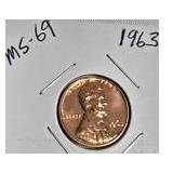 1963 Franklin Half Dollar, graded MS-69, plus four pennies from 1961 and 1963 with varying grades and defects.