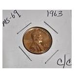 1963 Franklin Half Dollar, graded MS-69, plus four pennies from 1961 and 1963 with varying grades and defects.