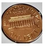 1963 Franklin Half Dollar, graded MS-69, plus four pennies from 1961 and 1963 with varying grades and defects.