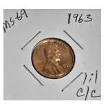 1963 Franklin Half Dollar, graded MS-69, plus four pennies from 1961 and 1963 with varying grades and defects.