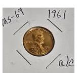 1963 Franklin Half Dollar, graded MS-69, plus four pennies from 1961 and 1963 with varying grades and defects.