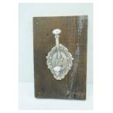Ornate Metal Hook on Vintage Wood Board